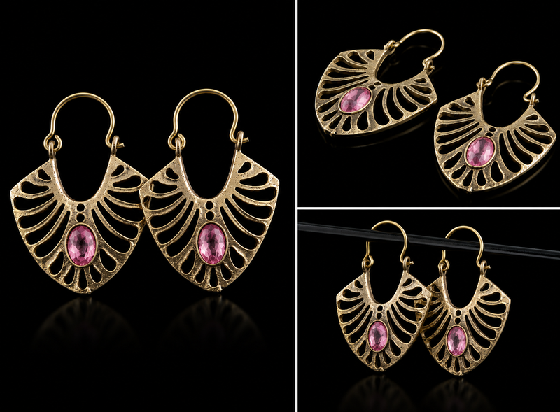 Gold earrings with pink gemstones on a black background