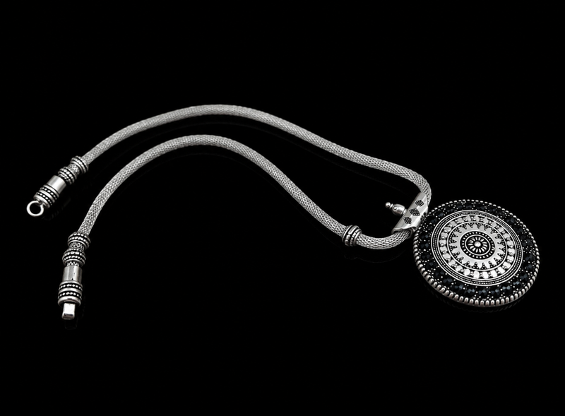 Silver stethoscope with decorative elements on a black background