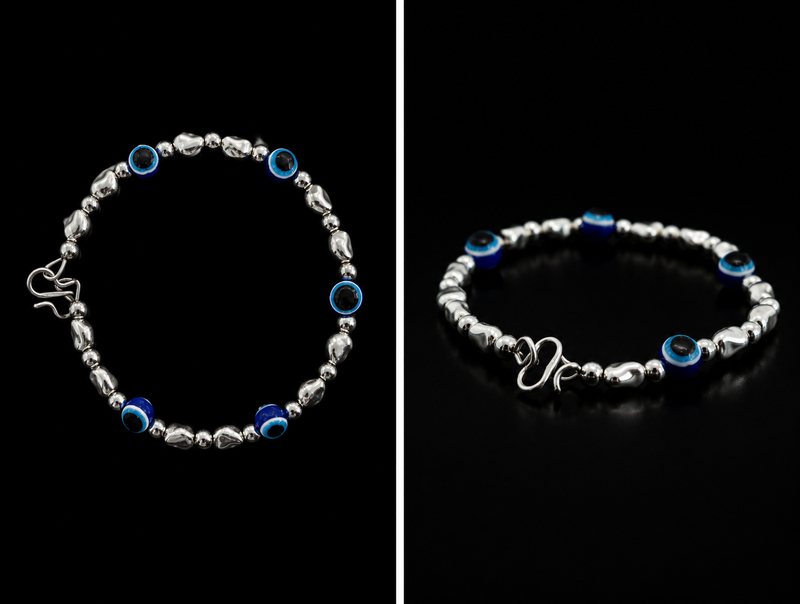 Silver bracelet with blue beads on a black background
