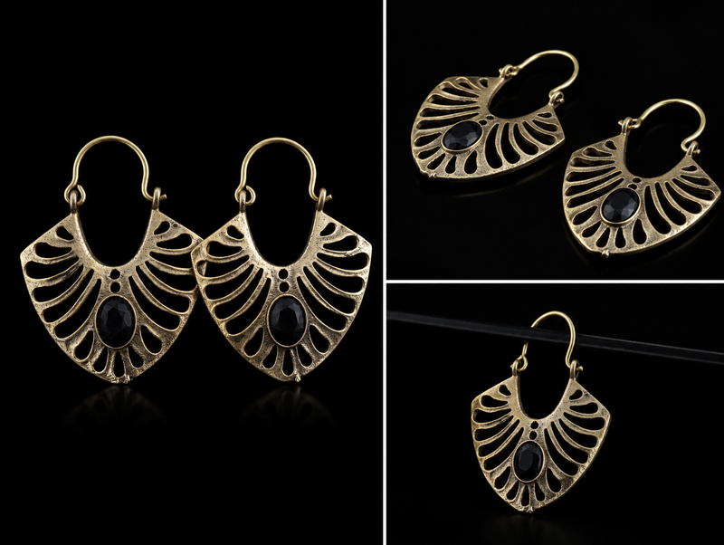 Bronze earrings with black stones on a black background