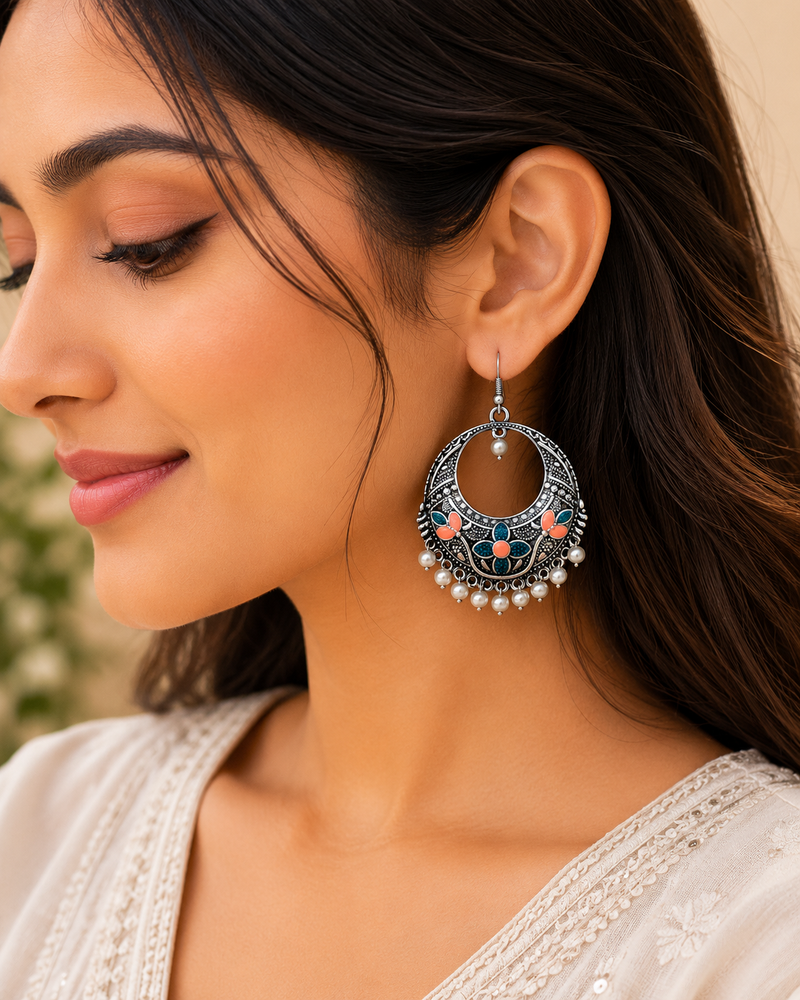 Close-up of a woman wearing a decorative earring with a blurred background