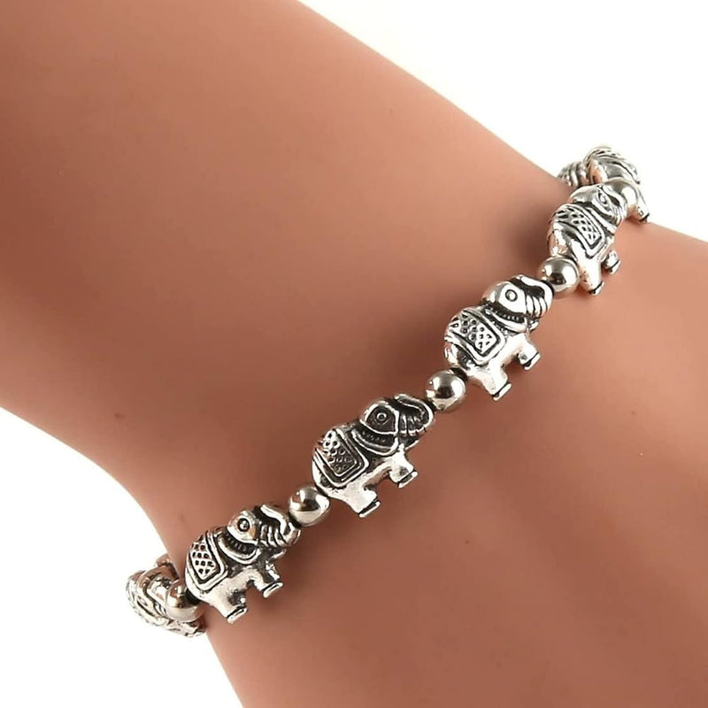 Silver elephant bracelet on a wrist against a white background