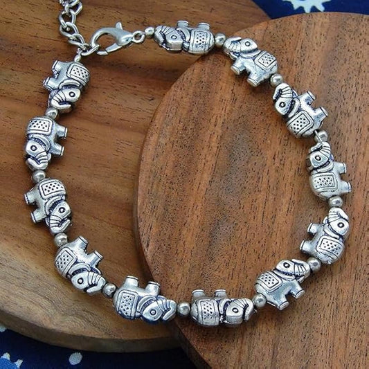 Silver elephant bracelet on a wooden surface
